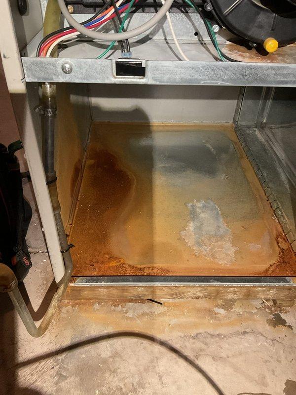 Responded to no-heat service call for 18-year-old natural gas furnace. Diagnostic inspection revealed unit overheating with burning smell and cold air distribution. Identified significant water damage, corrosion, and standing water in drain pan causing system failure. Customer opted for complete system replacement due to age and extent of damage.