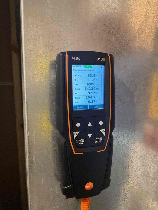 Responded to emergency no-heat call for 10+ year old natural gas furnace previously shut down by gas company due to dangerous carbon monoxide readings. Diagnostic testing with Testo analyzer confirmed critical CO levels exceeding 6300 ppm (14,000 ppm air-free), indicating severe heat exchanger failure. Inspection revealed significant secondary heat exchanger clogging, rendering the unit unsafe for operation. Recommended and scheduled complete system replacement due to age of equipment and non-repairable safety hazard.