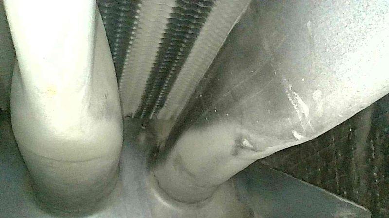 Responded to emergency no-heat call for 10+ year old natural gas furnace previously shut down by gas company due to dangerous carbon monoxide readings. Diagnostic testing with Testo analyzer confirmed critical CO levels exceeding 6300 ppm (14,000 ppm air-free), indicating severe heat exchanger failure. Inspection revealed significant secondary heat exchanger clogging, rendering the unit unsafe for operation. Recommended and scheduled complete system replacement due to age of equipment and non-repairable safety hazard.