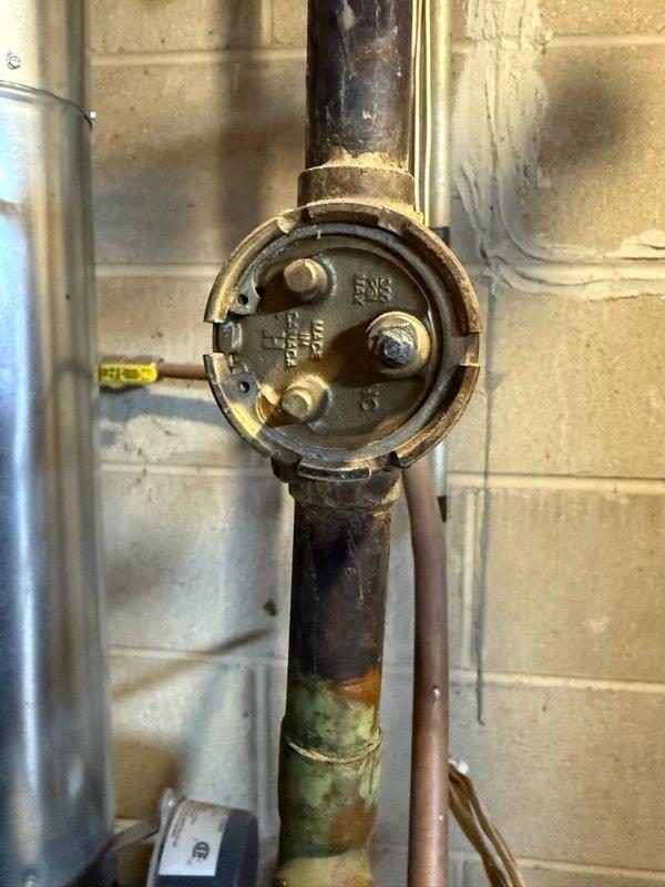 Responded to emergency call for overheating home. Diagnosed detached boiler stat and zone valve motor that had fallen off. Documented system condition with photos showing corrosion on copper piping and the disconnected valve components. Completed parts order form for replacement zone valve motor and advised customer of findings.