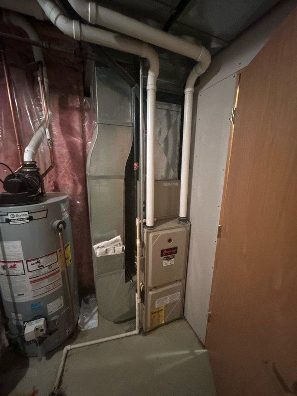 Diagnosed Amana gas furnace (Model CCA24FCC) with no heat issue. Determined pressure switch fault causing system failure. Found inducer motor humming but not turning. Attempted to free locked motor temporarily but it continued to stick. Identified cracked collector box as additional concern. Customer approved replacement of inducer motor and collector box to restore proper heating operation.