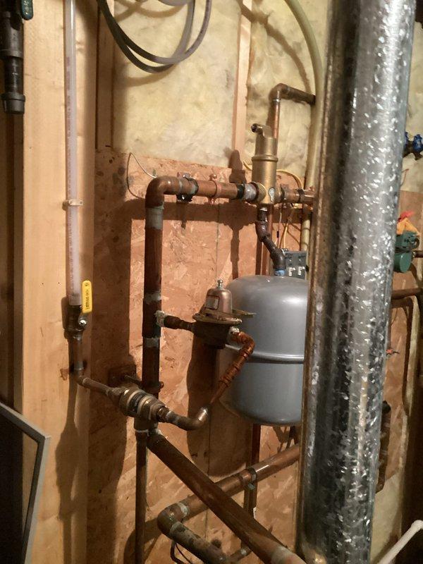 Responded to a service call for an in-floor heating system powered by a 19-year-old boiler with diminished heating performance. Diagnosed low water pressure causing system shutdown, restored pressure, and performed comprehensive system check of zone valves, manifolds, pumps, and controls. Identified damaged control board on radiant heat mixing block and noisy air handler relay pump; flushed discolored water from loops and temporarily restored boiler operation while preparing estimate for necessary component replacements including sensors.