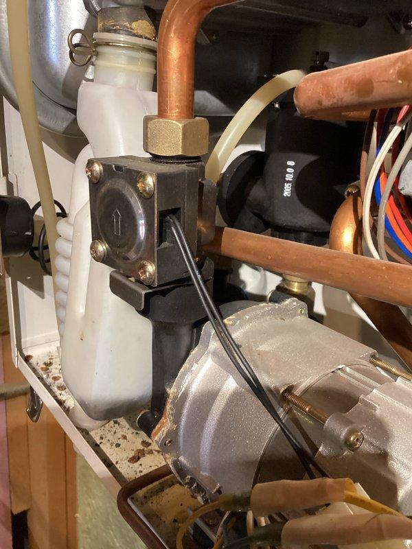 Diagnosed and repaired Navien boiler showing error code 13 (heating flow switch fault). Found defective flow sensor valve assembly causing intermittent operation failure after 8-12 hours of run time. Replaced flow switch assembly and verified proper system operation with no additional fault codes during extended test cycle.