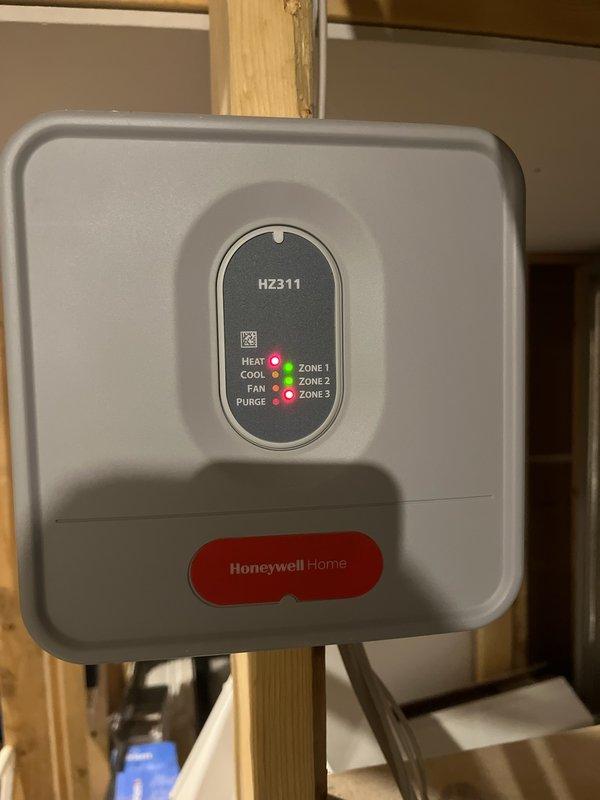 Responded to no heat call on a 5-year-old Honeywell furnace that was blowing cold air. Diagnostic inspection revealed Zone 3 had a red indicator light on the HZ311 zone control panel. Identified failed high limit switch that would not reset. Replaced limit switch, restoring proper heating function to the system.