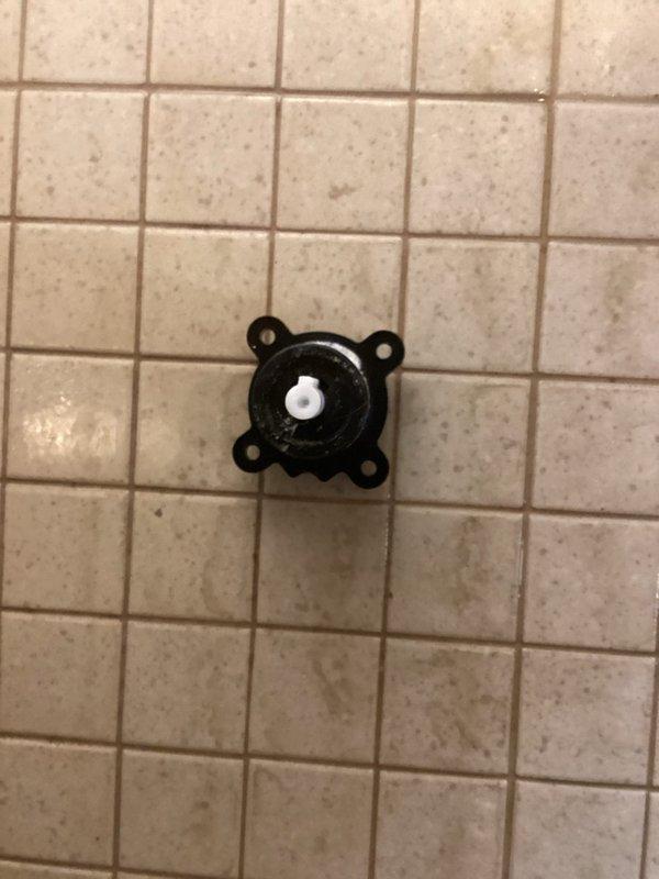 Diagnosed and replaced faulty shower cartridge within the valve body to resolve leaking issues from the shower head and diverter switch. Inspection of the exposed valve assembly revealed mineral buildup and wear requiring complete cartridge replacement rather than repair.