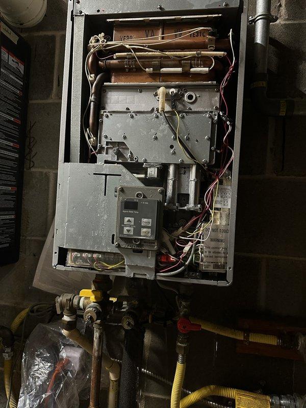 Responded to service call for commercial tankless water heater system with leak. Upon inspection, identified one non-functioning unit in a three-heater cascade configuration was leaking. Attempted to isolate the leaking unit using existing valves, but valves were inoperable. Successfully capped the hot and cold 3/4" copper supply lines to the third heater to eliminate the leak while maintaining operation of the two functional units.