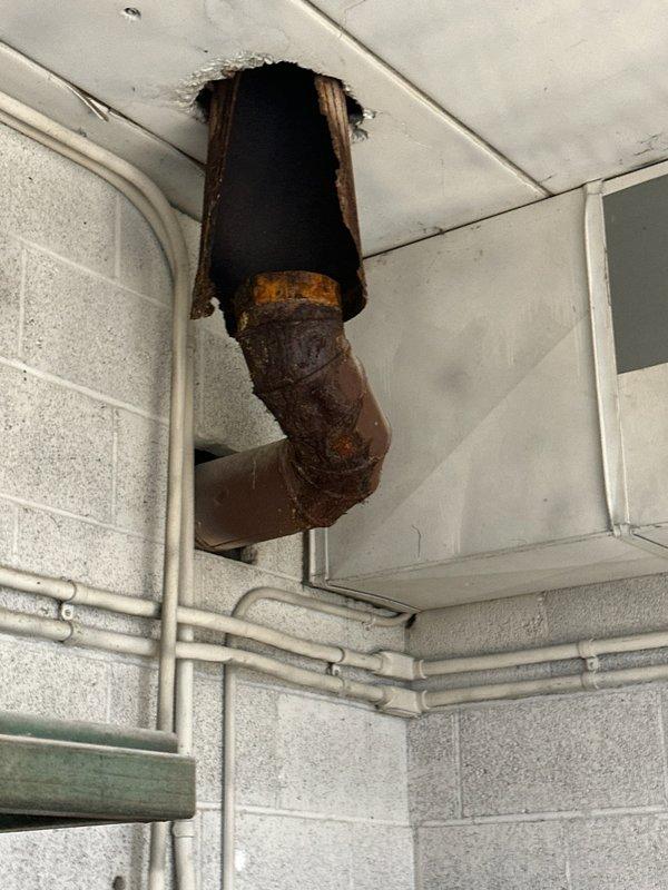 Technician identified a disconnected exhaust pipe from the furnace with significant rust deterioration and structural failure. Inspection revealed the original installation was incomplete, as not all venting components were properly replaced. Temporary evaluation completed and parts order submitted for appropriate venting materials. Return service scheduled to complete the necessary exhaust system repairs.