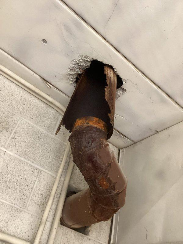 Technician identified a disconnected exhaust pipe from the furnace with significant rust deterioration and structural failure. Inspection revealed the original installation was incomplete, as not all venting components were properly replaced. Temporary evaluation completed and parts order submitted for appropriate venting materials. Return service scheduled to complete the necessary exhaust system repairs.