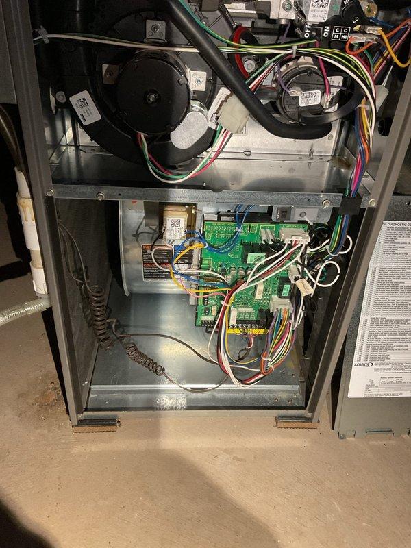 Responded to call for Lennox NG furnace (6 years old) that was shutting down intermittently. Customer reported unit would run for extended periods then cease operation, with operation restored after blower door removal. Diagnosed and removed shipping bolt still attached to blower housing, which was causing operational issues. Applied dielectric grease to motor module connections to prevent future connectivity problems. Tested unit through multiple on/off cycles to confirm proper operation. Unit now functioning normally.