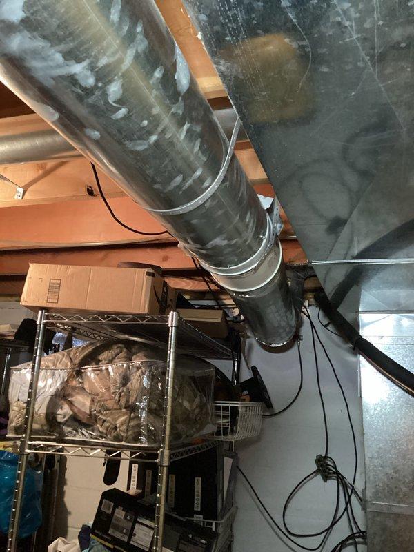 Responded to customer report of booster fan making rattling noises, causing insufficient heating in upper level of residence. Upon inspection, discovered booster fan piping was inadequately secured, with motor vibrating against floor joist in ceiling cavity. Corrective action included readjusting the motor position and installing additional securing points for the ductwork to eliminate vibration. System now operating properly with no further rattling observed.