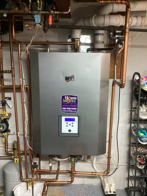 Responded to service call for an NTI combi boiler providing lukewarm domestic hot water despite adequate space heating functionality. Diagnosed issue with domestic water side of unit, performed full flush of holding tank to remove potential mineral buildup or sediment. After refilling and allowing proper heating cycle, system now producing appropriate hot water temperatures for all household fixtures.