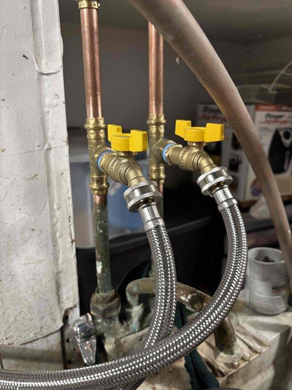 Replaced defective main shut-off valve that was non-operational. Installed new washer valves and supply hoses to address leakage issues. Completed service by replacing street side valve to resolve persistent leaking at laundry connections.