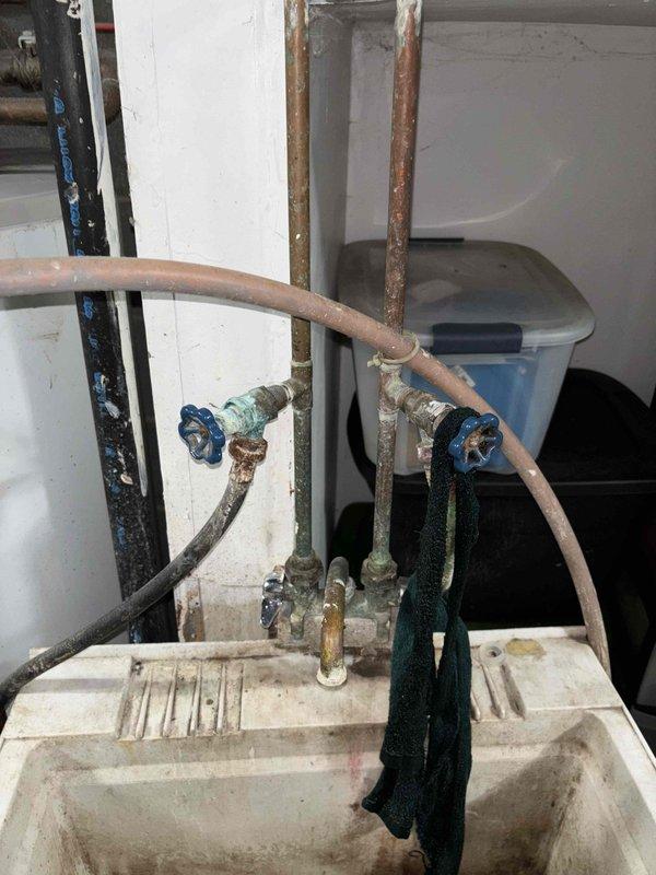 Replaced defective main shut-off valve that was non-operational. Installed new washer valves and supply hoses to address leakage issues. Completed service by replacing street side valve to resolve persistent leaking at laundry connections.