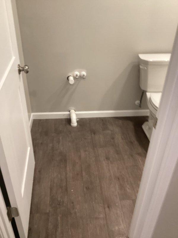 Completed installation of standard height toilet in bathroom renovation project after customer's flooring work was finished. Successfully connected water supply to existing rough-in plumbing and verified proper operation. Shower/tub installation remains pending customer's completion of vanity and countertop placement.