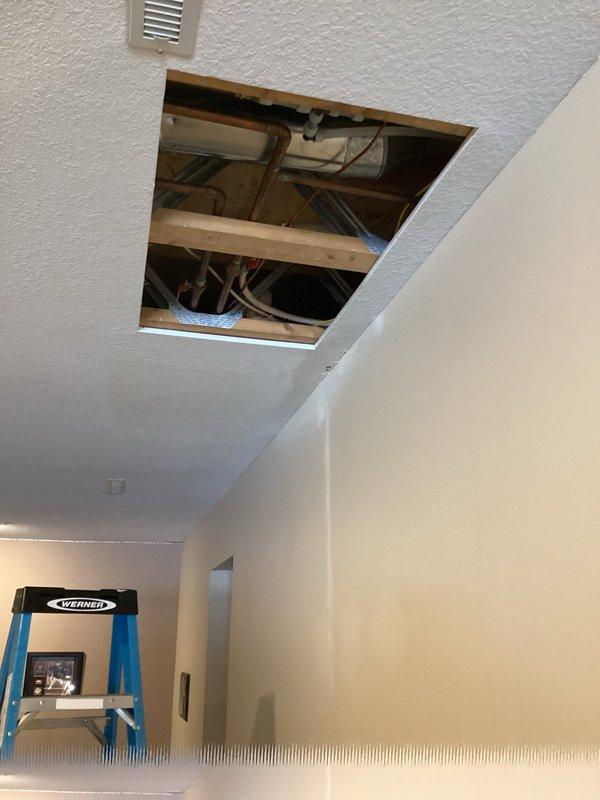 Responded to urgent service call for leaking ABS drain pipe located in wall behind lazy Susan and visible through ceiling. Accessed plumbing through ceiling access panels to diagnose issue. Identified source of leak in main drain line causing water damage to ceiling. Performed necessary repairs to compromised drain piping to resolve the active leak.