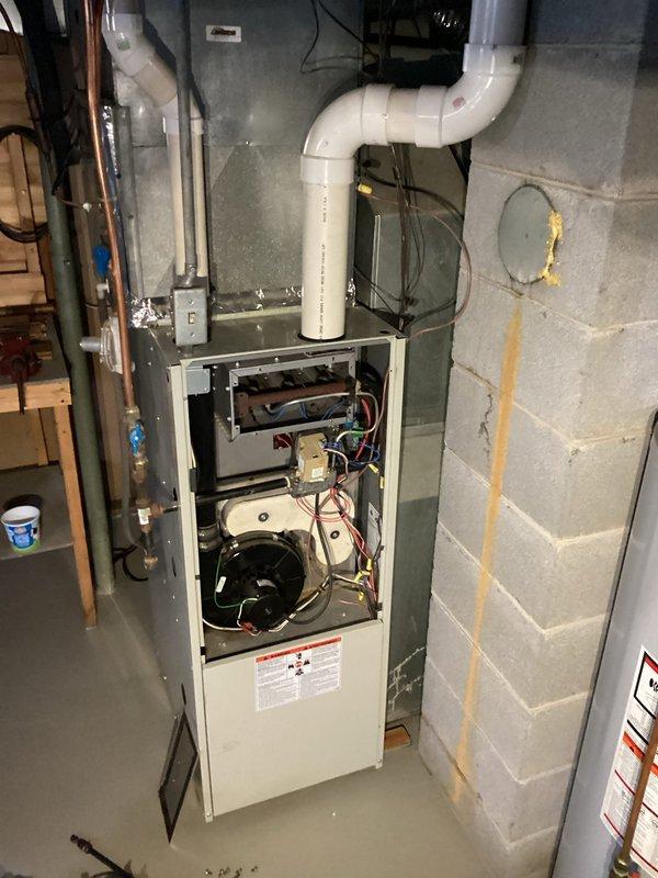Performed tune-up on 27-year-old Heil furnace. Diagnosed vibrating noise in basement traced to condensation pump. Inspected heat exchanger and found questionable areas requiring attention. Documented condition of gas valve (SV9501M 2726) and overall system configuration for follow-up recommendations.
