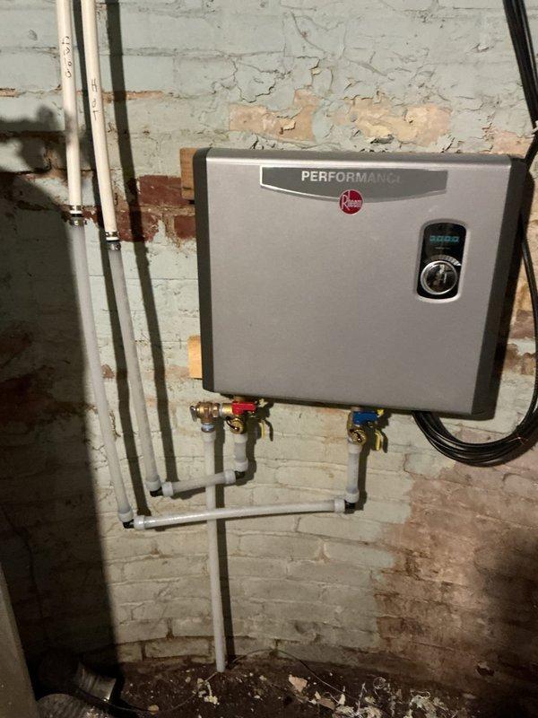 Performed descaling service on Rheem Performance tankless water heater that was initially providing hot water but quickly turning cold. Installed flush kits on unit and re-piped a section of water line to facilitate proper maintenance. Conducted three complete flush cycles to remove significant sediment accumulation from the system. Ran all household faucets multiple times to clear sediment from lines, restoring proper hot water function.