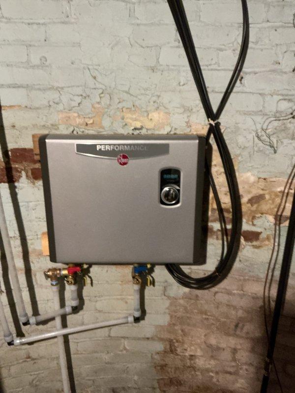 Performed descaling service on Rheem Performance tankless water heater that was initially providing hot water but quickly turning cold. Installed flush kits on unit and re-piped a section of water line to facilitate proper maintenance. Conducted three complete flush cycles to remove significant sediment accumulation from the system. Ran all household faucets multiple times to clear sediment from lines, restoring proper hot water function.