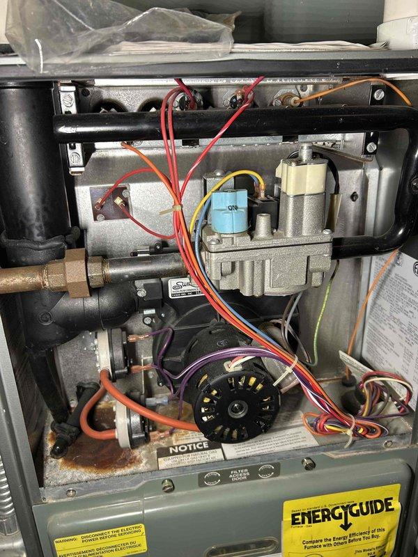 Performed standard preventative maintenance on residential furnace of unknown age. System inspection included heat exchanger evaluation, combustion analysis, gas pressure testing (high/low stages), flame sensor inspection, burner examination, and blower assembly check. All components functioning normally with no immediate concerns identified. Air filter in moderate condition, pressure switch cleaned, and thermostat operation verified with adequate heating performance confirmed.