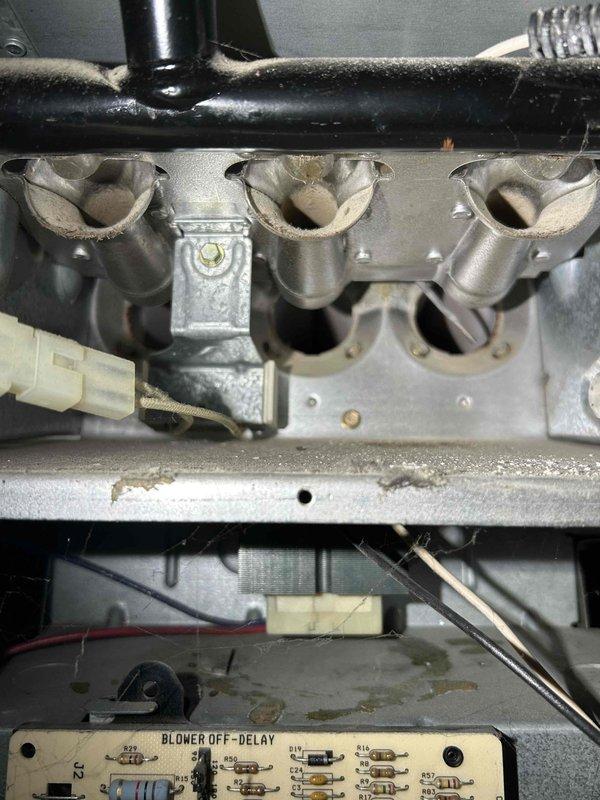 Performed comprehensive furnace tune-up on forced air system of unknown age. System operating normally except for rattling/wobbling inducer motor with abnormally low resistance readings. Completed full diagnostic sequence including heat exchanger inspection, combustion analysis, gas pressure verification, flame sensor and burner inspection, and blower motor assessment. Cleaned pressure switch and verified proper thermostat operation. Recommended inducer motor replacement and filter change as maintenance priorities.