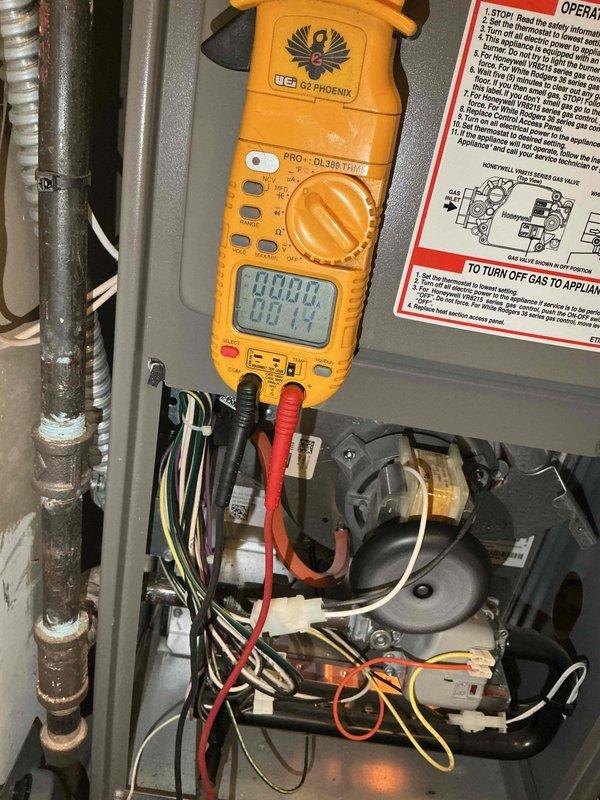 Diagnosed 5-year-old natural gas furnace with intermittent operation and no heat. Testing with UEi DL379 Phoenix clamp meter confirmed flame sensor failure. Replaced failing flame sensor under parts warranty, restoring normal heating operation.