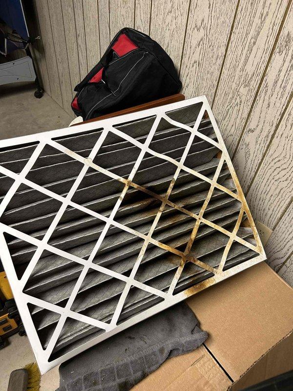 Responded to emergency gas leak call with furnace shut down. Inspection revealed clogged secondary heat exchanger causing gas to leak into filter area and intermittent heating issues. Recommended replacement of either complete furnace unit or heat exchanger to resolve safety hazard and restore proper heating function.