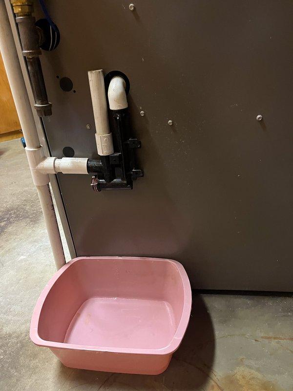 Responded to water leakage issue near furnace caused by cracked condensate trap. Replaced trap, performed comprehensive furnace maintenance including component inspection, replacement of humidifier panel and furnace filter, cleaning of routine components, and unclogging of furnace drain. System now operating properly with no leaks observed.