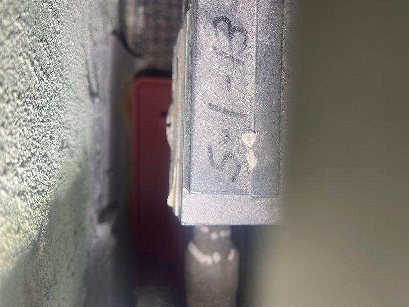 Responded to no-heat complaint in commercial building. Investigated zone valve serving Matt's office and found it stuck in closed position. Manually freed valve to restore heat flow. Noted significant mineral deposits on the aging valve (appears to be original to building) and minor dripping. Recommended eventual replacement of 5-1/3" zone valve. Submitted parts request form for future replacement estimate.