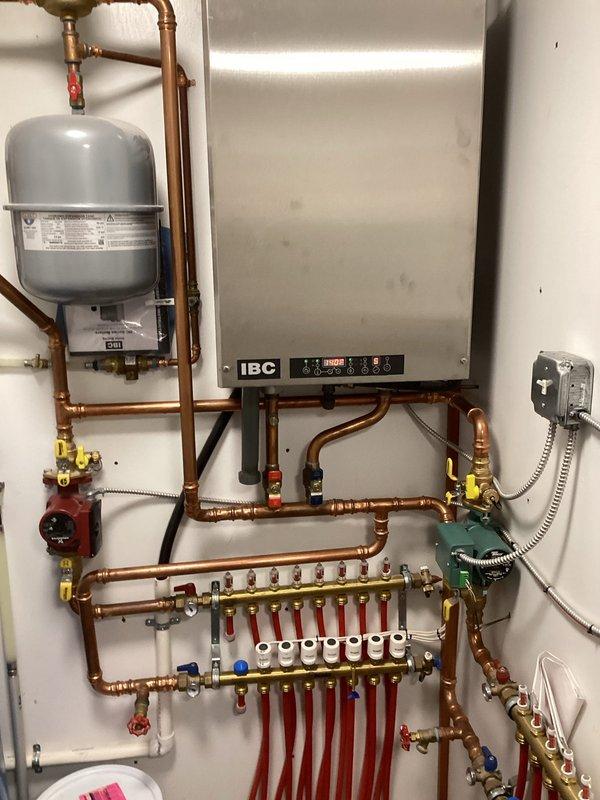 Responded to customer concern of IBC HC boiler (4 years old) randomly shutting down. Performed overdue maintenance service including thorough heat exchanger cleaning and system water replenishment to restore proper pressure. Unit was successfully tested with all zones functioning correctly and proper ignition verified. Determined that accumulated debris and low water pressure were the likely causes of the intermittent shutdowns.