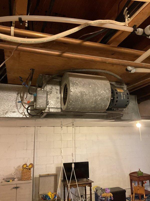 Diagnosed and resolved no heat issue in basement zone with fan coil and mercury thermostat. Upon inspection, discovered disconnected wire from end switch to relay to thermostat. Reconnected wire, restored system functionality with independent control for both upstairs and downstairs thermostats. Equipment inspected included CF5282868 unit and ceiling-mounted blower assembly in basement utility area.