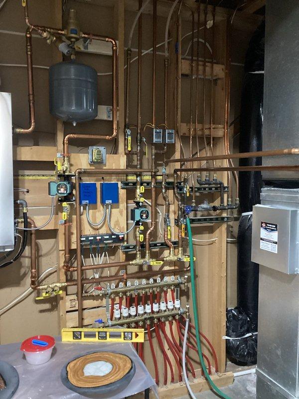 Responded to service call for floor heating issues in garage area of boiler system installed approximately 2 years ago. Upon inspection, verified thermostat was calling for heat and zone valve was functioning properly. After running system for 20 minutes, observed three loops heating normally while two loops (likely the longest exterior runs) remained cool. Explained to homeowner that the system appears to be operating as designed, with delayed heating in the furthest loops being expected behavior. Recommended continued monitoring of system performance.