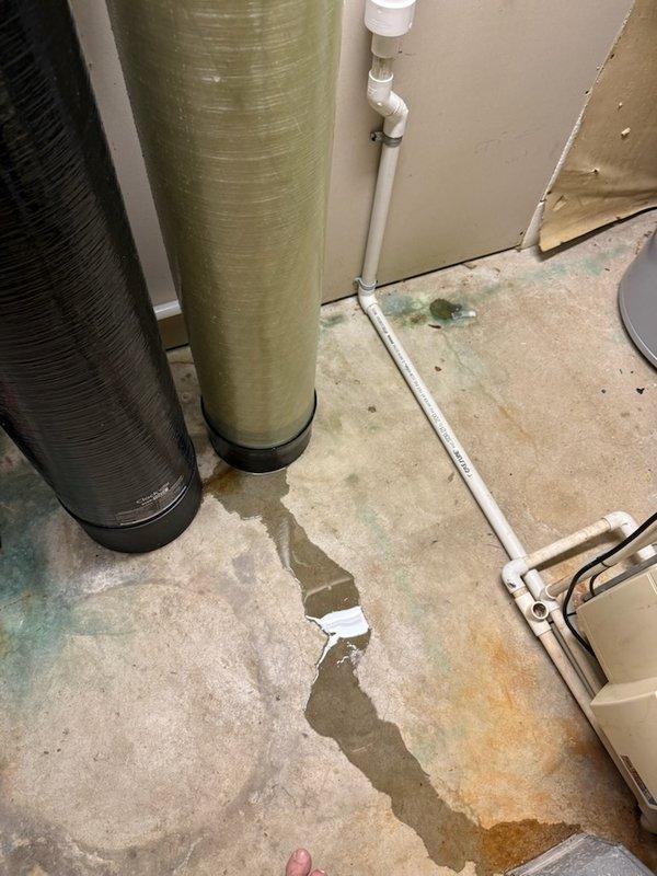 Responded to service call for acid neutralizer system installed 14 days prior that was leaking at a joint. Diagnosed issue as a cracked discharge adapter. Replaced discharge adapter on the Hurlburt water treatment system, successfully resolving the leak that had been causing water accumulation on the concrete floor near the dual-tank setup.