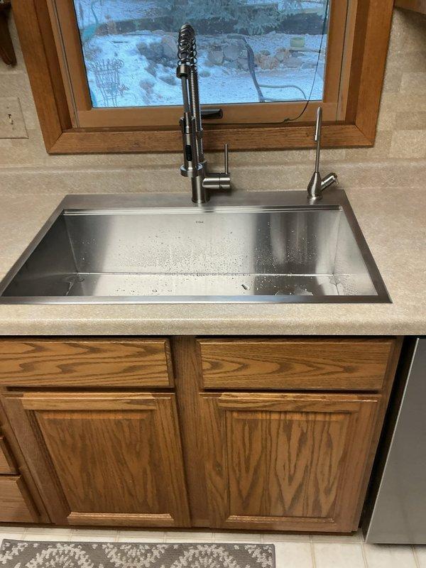 Completed installation of customer-supplied kitchen sink and faucet, including connection of all supply lines and drain assembly. Diagnosed and resolved drain clogging issue by performing thorough cleaning of drain line. Verified proper operation of new fixtures and ensured no leaks were present at supply and waste connections.
