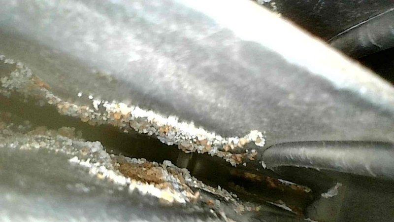 Diagnosed and inspected furnace that was shutting down shortly after ignition. Observed yellow/orange flames and excessive heat in burner box. Visual inspection revealed multiple pinholes throughout the secondary heat exchanger and condensate backup due to material deterioration. Documented damage with camera and showed evidence to homeowner. Determined unit required replacement due to compromised heat exchanger integrity. Removed existing furnace and scheduled follow-up with service advisor for replacement options.