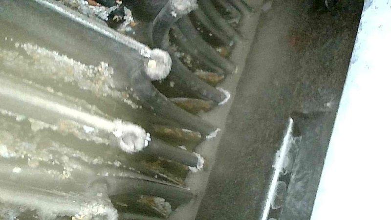 Diagnosed and inspected furnace that was shutting down shortly after ignition. Observed yellow/orange flames and excessive heat in burner box. Visual inspection revealed multiple pinholes throughout the secondary heat exchanger and condensate backup due to material deterioration. Documented damage with camera and showed evidence to homeowner. Determined unit required replacement due to compromised heat exchanger integrity. Removed existing furnace and scheduled follow-up with service advisor for replacement options.