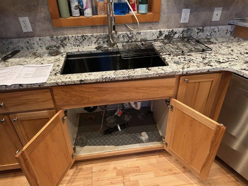 Successfully completed kitchen sink reconnection service, installing P-trap assembly and connecting drainage system with proper seals. Verified all connections for leaks and confirmed proper function of both basin drains, ensuring optimal water flow and drainage.