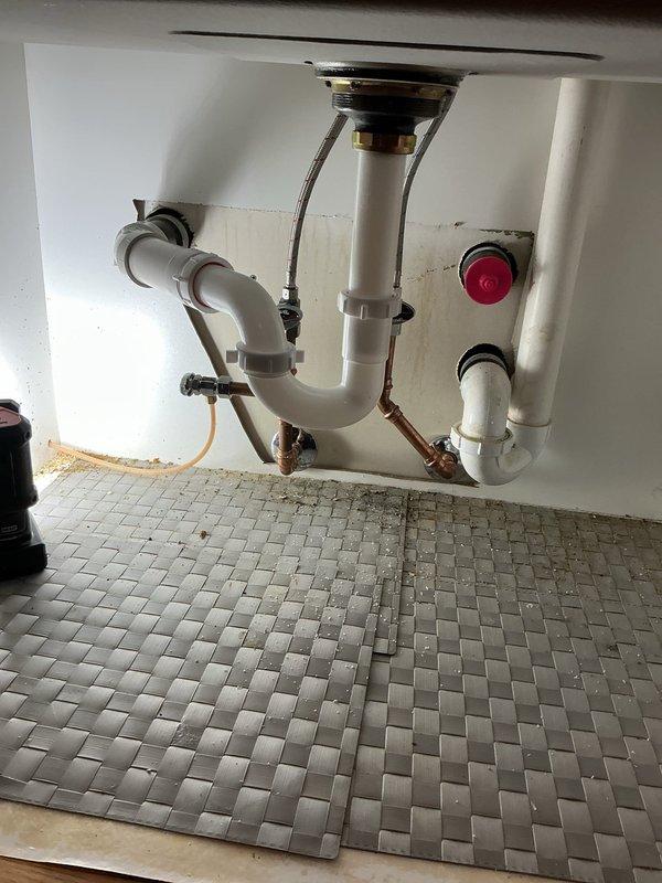 Successfully completed kitchen sink reconnection service, installing P-trap assembly and connecting drainage system with proper seals. Verified all connections for leaks and confirmed proper function of both basin drains, ensuring optimal water flow and drainage.