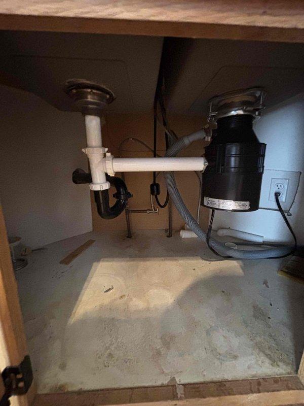 Responded to clogged kitchen sink drainage issue. Upon inspection, found blockage originated beneath concrete slab in basement rather than in under-sink plumbing. Successfully cleared obstruction by running cable through basement cleanout access point, restoring proper drainage function to kitchen sink.