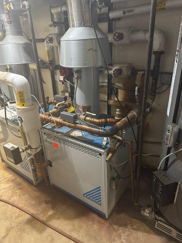 Responded to service call for Slant Fin boiler experiencing pressure loss and causing overheating in multiple apartments. System inspection revealed temporary repair previously performed by technician Jared. Filled boiler to restore proper pressure and confirmed system is burning safely despite tenant reports of loud pipes. Parts have been ordered for permanent repair.