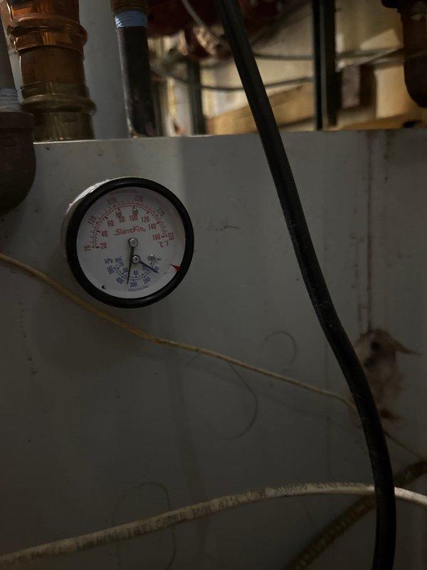 Responded to service call for Slant Fin boiler experiencing pressure loss and causing overheating in multiple apartments. System inspection revealed temporary repair previously performed by technician Jared. Filled boiler to restore proper pressure and confirmed system is burning safely despite tenant reports of loud pipes. Parts have been ordered for permanent repair.