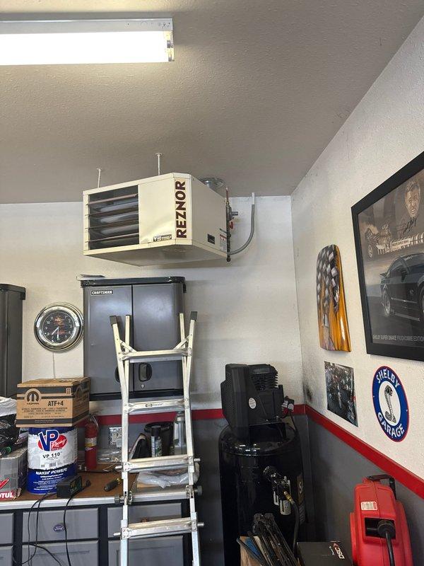 Responded to service call for 10-year-old Reznor garage heater with no heat issue. Diagnosed faulty gas valve preventing ignition despite blower operation. Replaced gas valve and confirmed proper system function with successful ignition cycle and heat production.