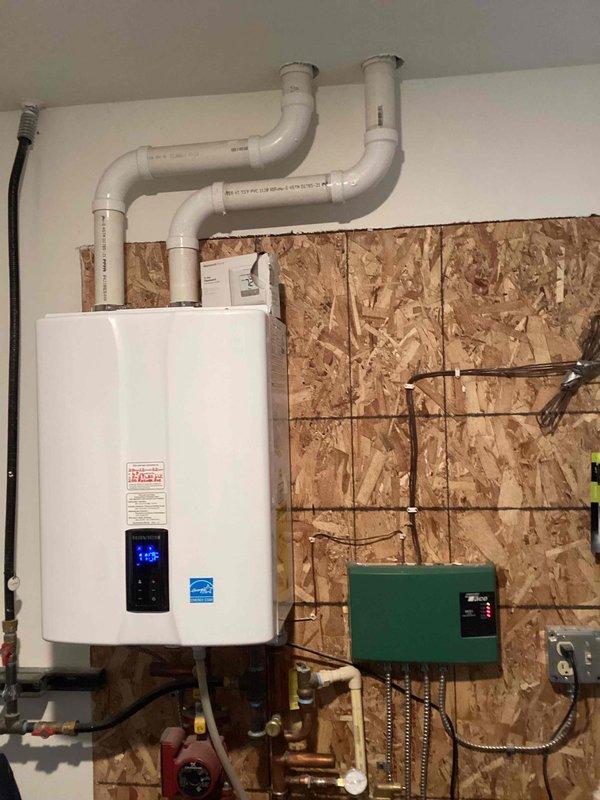 Diagnosed Navien boiler failure issue where unit would not restart after cycling off, requiring manual reset. Inspection revealed warped ignitor with severely corroded copper terminals showing oxidation and discoloration. Documented condition of 3-year-old system and informed customer that warranty repair pricing would be provided for the necessary ignitor replacement.