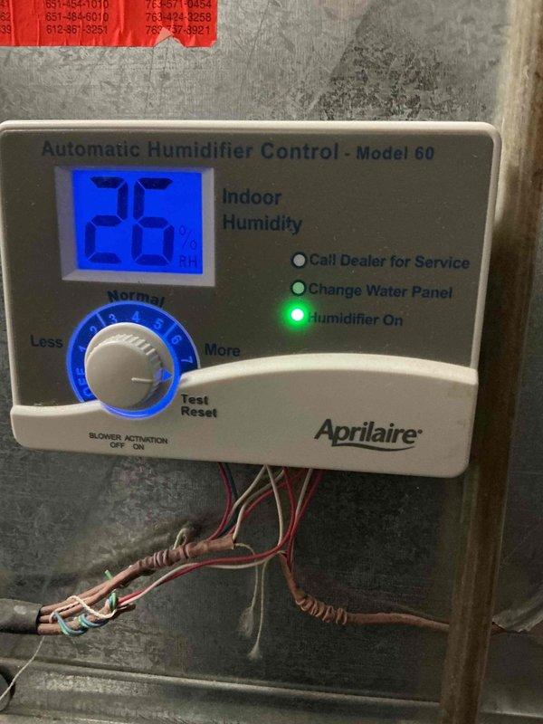 Diagnosed and serviced Aprilaire Automatic Humidifier Control Model 60 that was experiencing continuous operation with flashing yellow indicator light. Replaced humidifier filter which had visible dust accumulation and performed system reset to restore proper functionality. Successfully tested the unit to verify normal operation with proper on/off cycling.