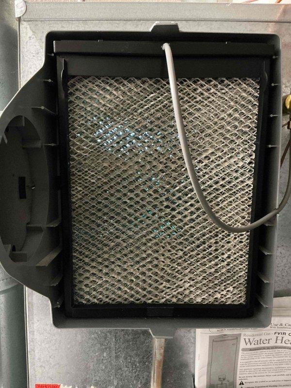 Diagnosed and serviced Aprilaire Automatic Humidifier Control Model 60 that was experiencing continuous operation with flashing yellow indicator light. Replaced humidifier filter which had visible dust accumulation and performed system reset to restore proper functionality. Successfully tested the unit to verify normal operation with proper on/off cycling.