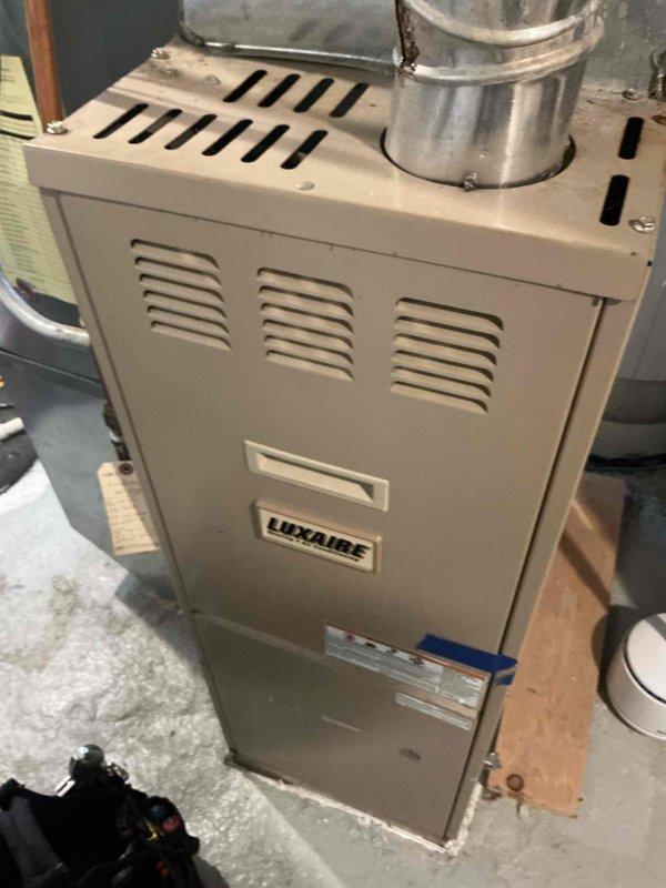 Diagnosed Luxaire furnace (22 years old) exhibiting no heat condition with board flashing error code for open high limit switch. Successfully restored function by resetting stuck limit switch, but noted it will likely fail again soon. Inspection revealed severely degraded igniter that remains operational for now. Verified heat exchanger integrity with no cracks or damage found. Recommended replacement of high limit switch and igniter to prevent future no-heat conditions. All other components tested and functioning properly.