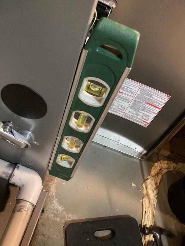 Diagnosed recurring no-heat condition caused by improper furnace installation pitch, which resulted in water accumulation in combustion blower. Corrected furnace slope using level tool to ensure proper drainage, resolving the intermittent operation and noise issues that had persisted despite previous service attempts.