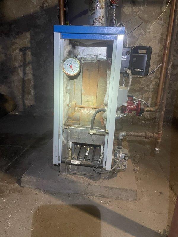 Diagnosed 15-year-old Slant Fin boiler with no heat issue. Determined gas valve failure - pilot light functioning properly but main burners not igniting despite verified 25V power supply to both ignition module and valve. Currently sourcing replacement part for repair completion.