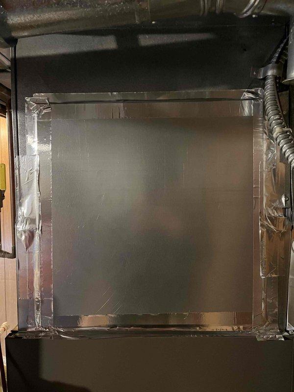 Responded to service call for previously repaired Aprilaire humidifier that had fallen again. Inspection revealed humidifier was improperly secured to the plenum with only tape rather than proper fasteners following previous system work. Observed pinched copper water line at saddle valve connection due to the fall. Documented condition with photos and recommended replacement of the damaged unit.