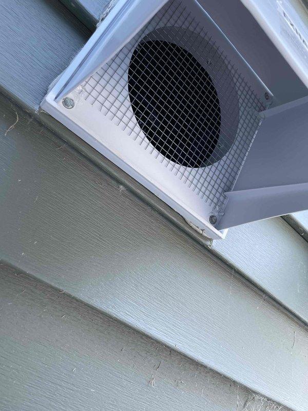 Addressed warranty issue with exterior HRV ventilation system. Found mesh screen had fallen out due to vent hood becoming unclipped. Reinstalled screen, secured vent hood with screw, and applied caulk to prevent future detachment. Also inspected secondary hood as requested - all components now properly secured and functional.
