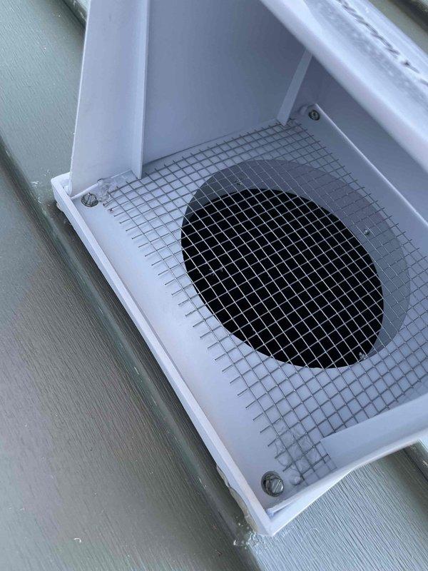 Addressed warranty issue with exterior HRV ventilation system. Found mesh screen had fallen out due to vent hood becoming unclipped. Reinstalled screen, secured vent hood with screw, and applied caulk to prevent future detachment. Also inspected secondary hood as requested - all components now properly secured and functional.